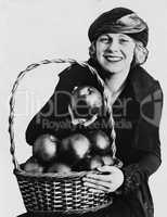 Portrait of woman with basket of apples