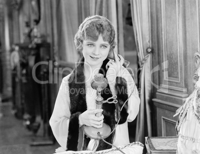 Portrait of woman using telephone