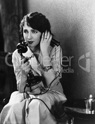 Distressed woman using telephone