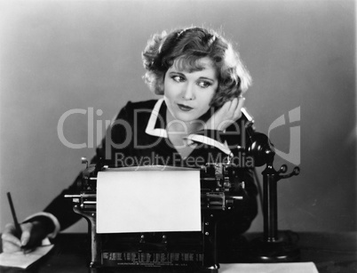 Woman at typewriter on telephone