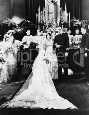 Portrait of wedding party at altar