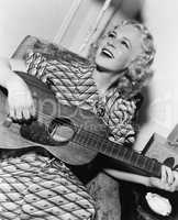 Woman playing guitar and singing
