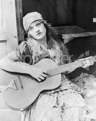 Portrait of woman playing guitar