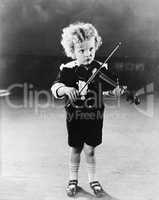 Portrait of little boy playing violin