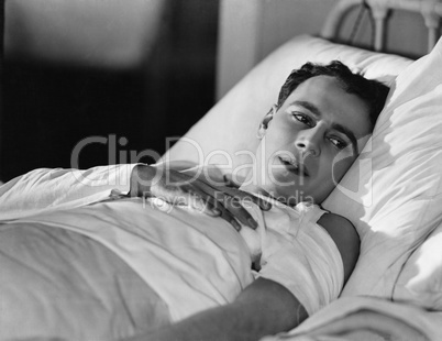 Portrait of injured man in bed