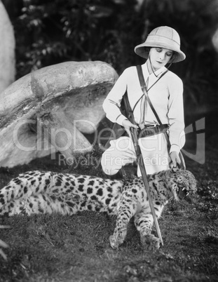 Female hunter with dead leopard