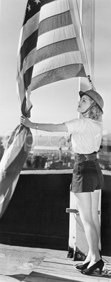 Woman raising American flag