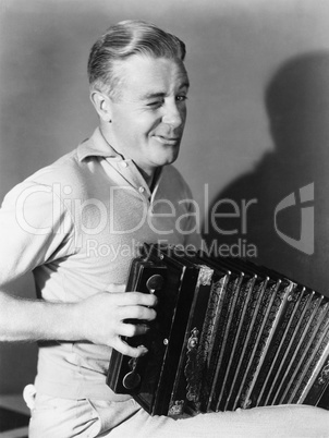 Winking man playing accordion