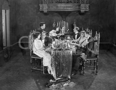Group of people having dinner party