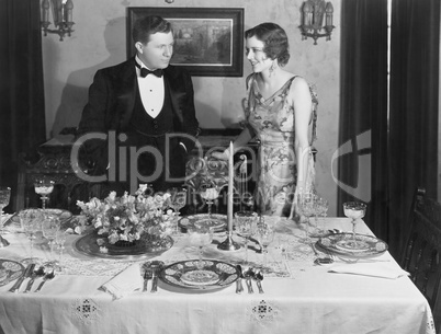 Couple with table set for dinner
