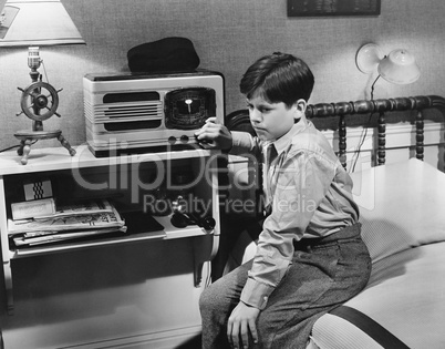 Boy listening to radio in bedroom