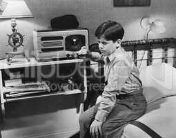 Boy listening to radio in bedroom