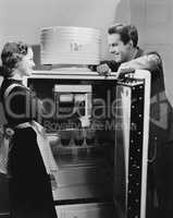 Couple with open refrigerator