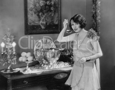 Portrait of woman with ladle and punch bowl