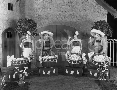 Women posing with huge baskets of eggs