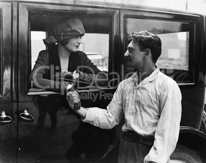 Man saying goodbye to woman in car