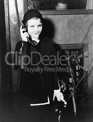 Portrait of woman using telephone