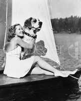 Woman and dog on sailboat