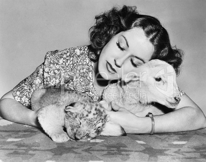 Woman with sleeping lamb and lion cub