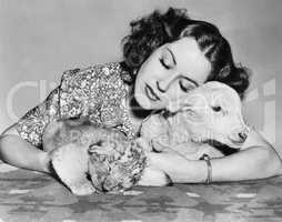 Woman with sleeping lamb and lion cub