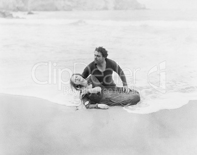 Man rescuing woman from ocean