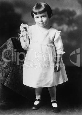 Portrait of little girl with doll