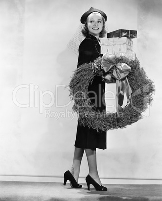 Woman carrying packages and Christmas wreath