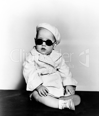 Portrait of baby wearing beret and sunglasses