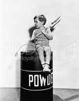 Little boy sitting on powder keg