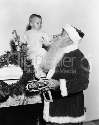 Santa Claus with baby on mantle