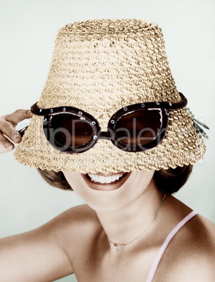 Woman wearing hat with fake sunglasses