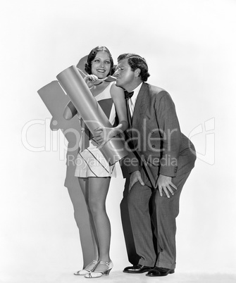 Playful man and woman lighting explosive with cigarette