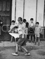 Kids playing bullfighting game in street