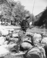 Woman fishing in river