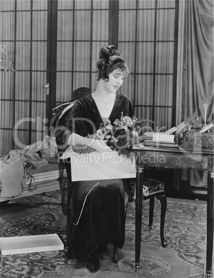 Woman opening box of flowers