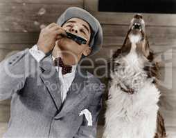 Man playing harmonica with howling dog