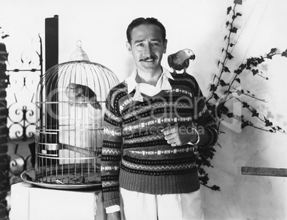 Man posing with pet birds