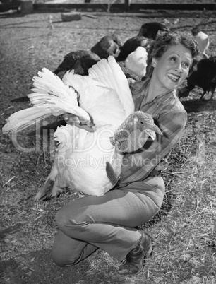 Woman holding live turkey