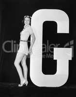 Woman posing with huge letter G