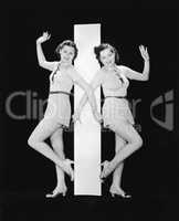 Women posing with big letter I