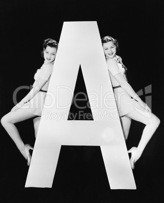 Two women with huge letter A