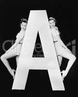 Two women with huge letter A
