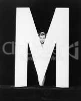 Womans face with huge letter M