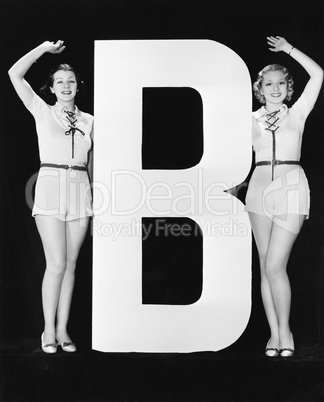 Women waving with huge letter B