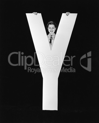 Woman posing behind huge letter Y