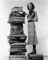 Woman with pile of large books
