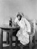 Chimpanzee dressed as woman with bottle and shot glass