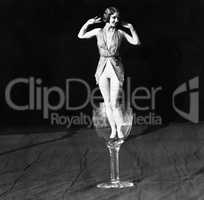 Tiny woman standing in wineglass