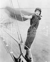 Woman leaning off boat into the wind