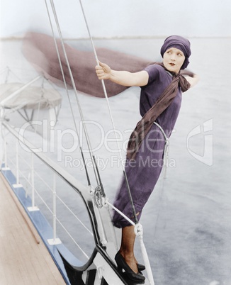 Woman leaning off boat into the wind